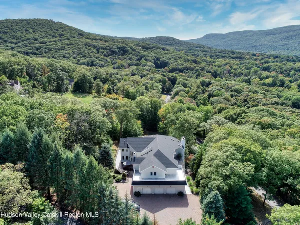 an aerial view of a house with a yard
