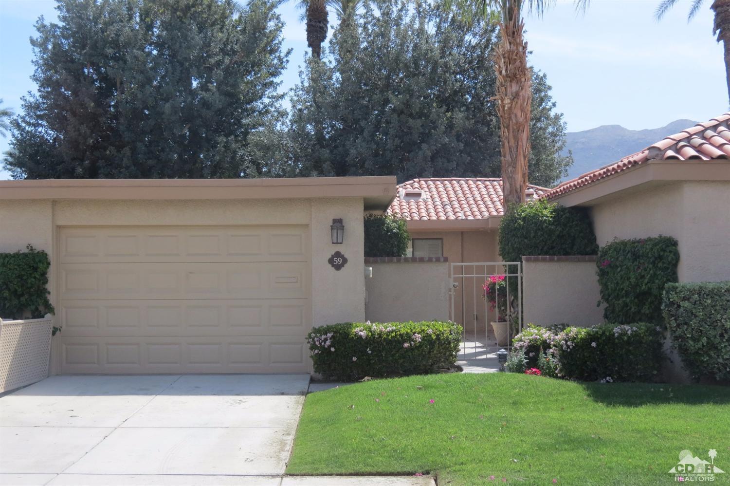 59 La Ronda Drive Rancho Mirage, CA 92270 - Photo 1 of 27 a front view of a house with a garden
