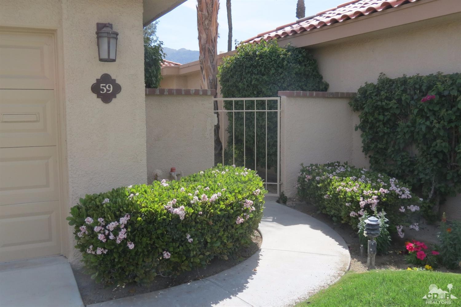 59 La Ronda Drive Rancho Mirage, CA 92270 - Photo 2 of 27 a couple of flowers are in front of a door
