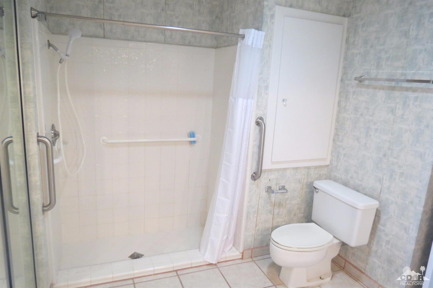 59 La Ronda Drive Rancho Mirage, CA 92270 - Photo 21 of 27 a bathroom with a shower and a toilet