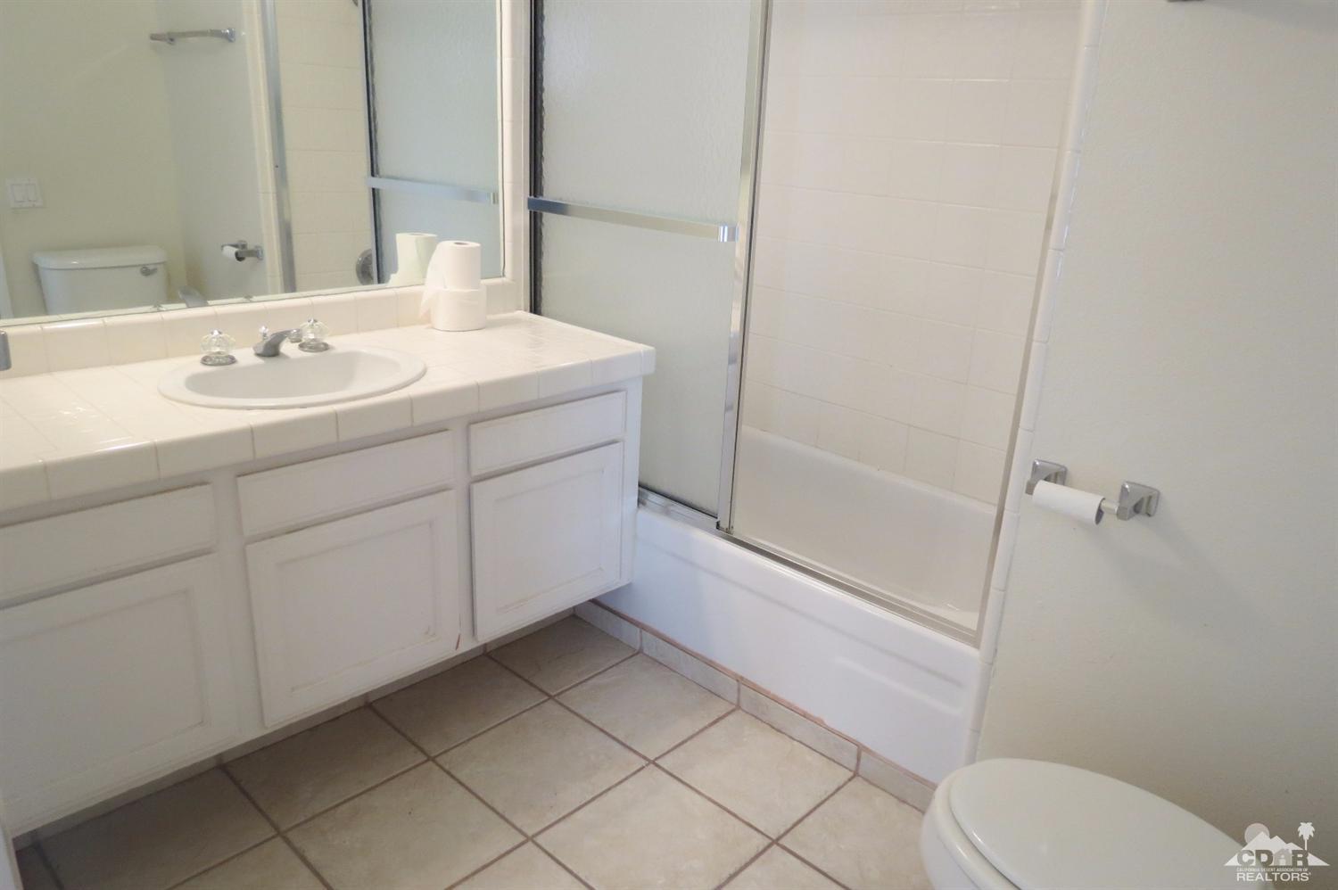59 La Ronda Drive Rancho Mirage, CA 92270 - Photo 24 of 27 a bathroom with a sink a toilet and shower