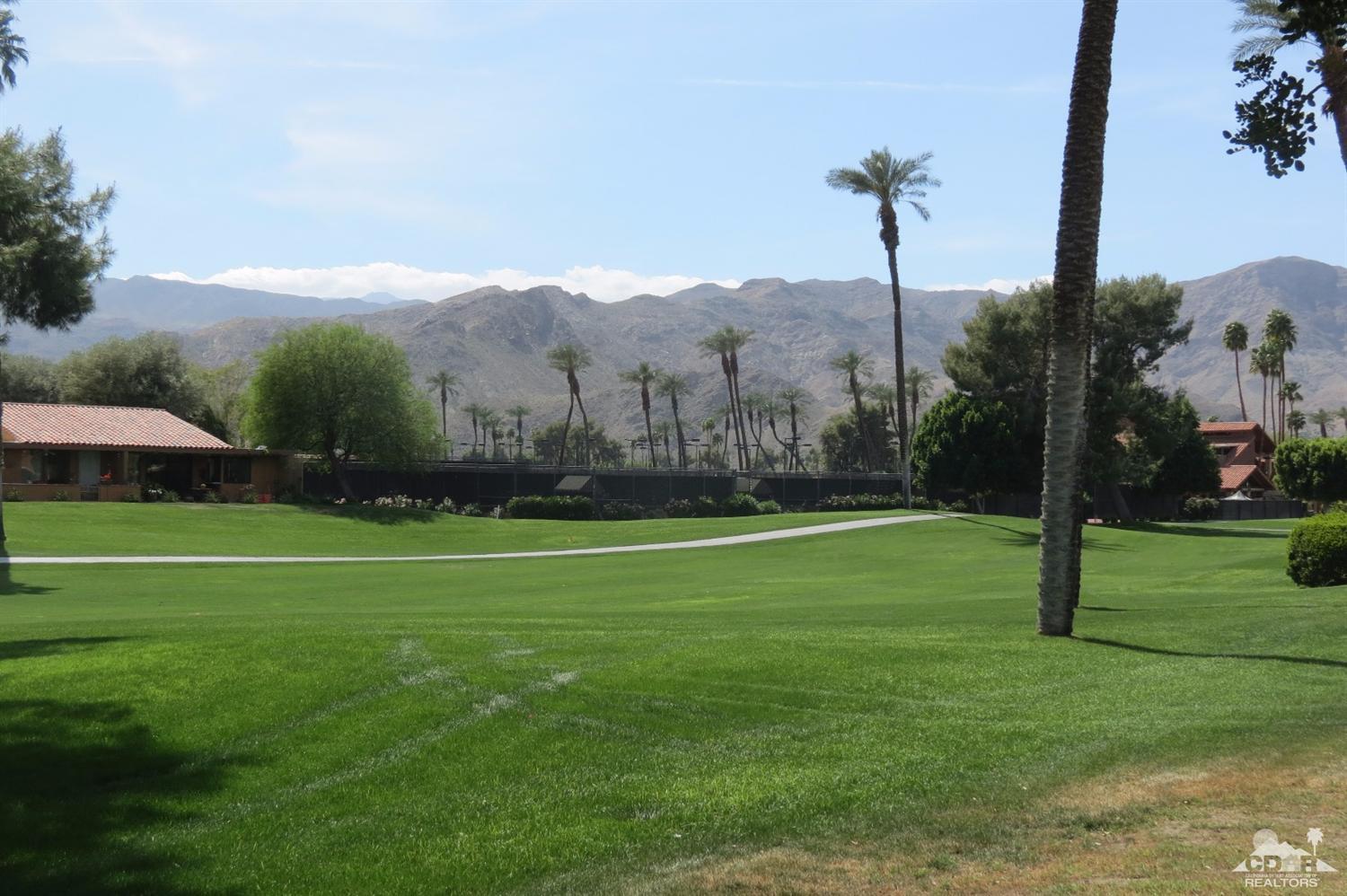 59 La Ronda Drive Rancho Mirage, CA 92270 - Photo 6 of 27 a view of a grassy field with a tree
