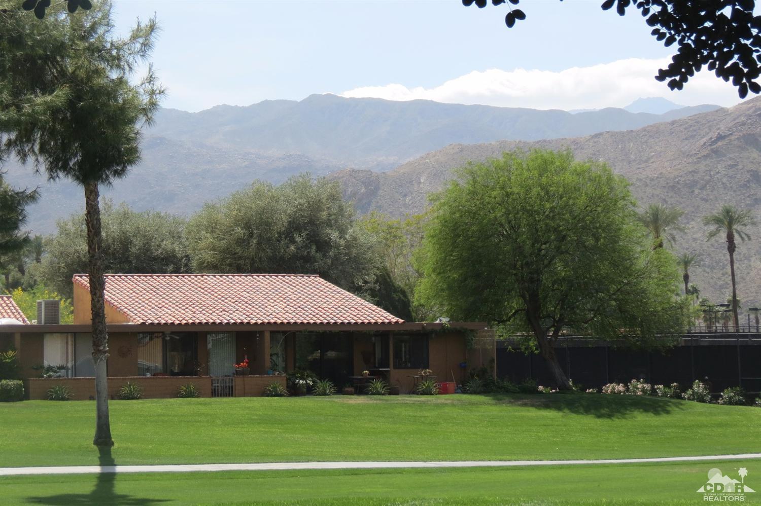 59 La Ronda Drive Rancho Mirage, CA 92270 - Photo 7 of 27 a view of a white house in a big yard with palm trees