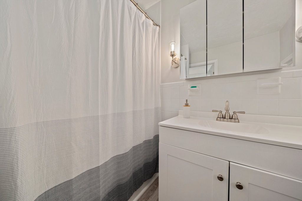 86 High Street Randolph, MA 02368 - Photo 11 of 28 a bathroom with a sink and vanity