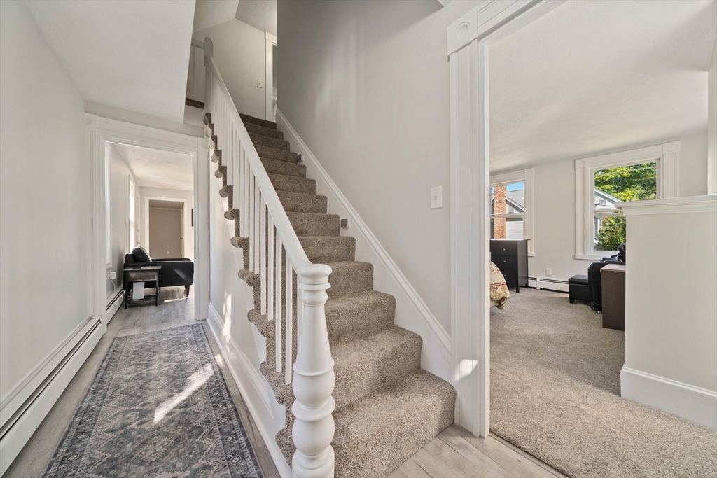 86 High Street Randolph, MA 02368 - Photo 12 of 28 a view of a livingroom with furniture and stairs