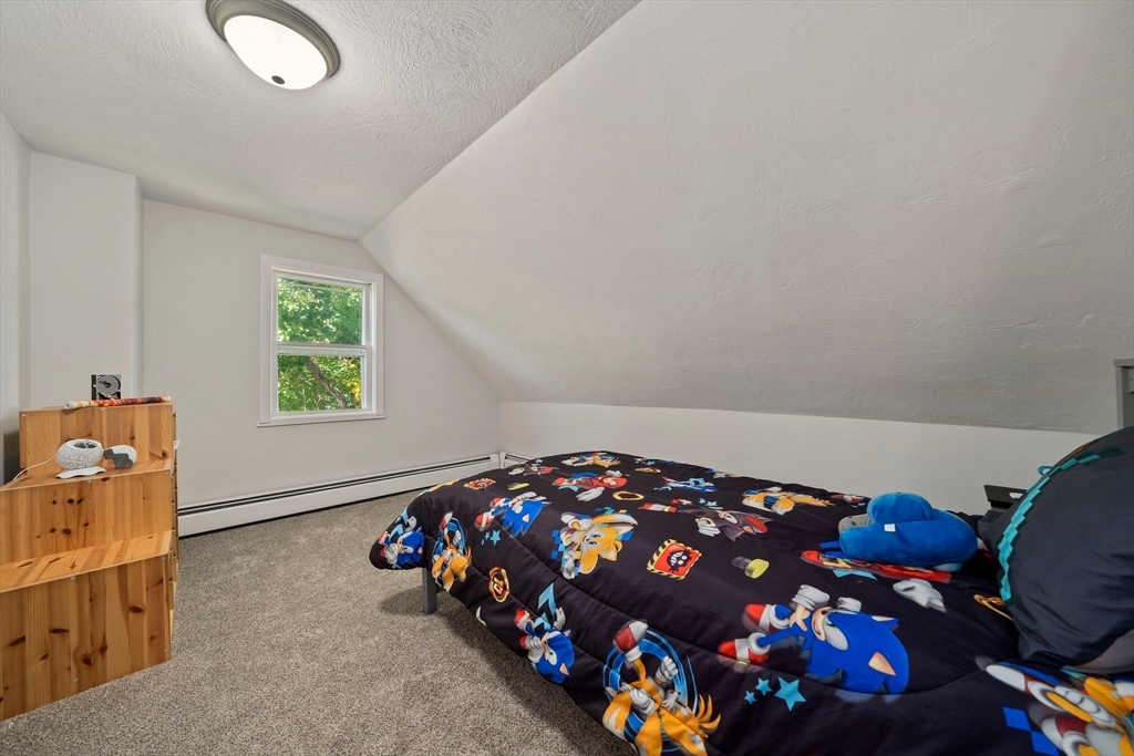 86 High Street Randolph, MA 02368 - Photo 16 of 28 a bedroom with furniture and a window