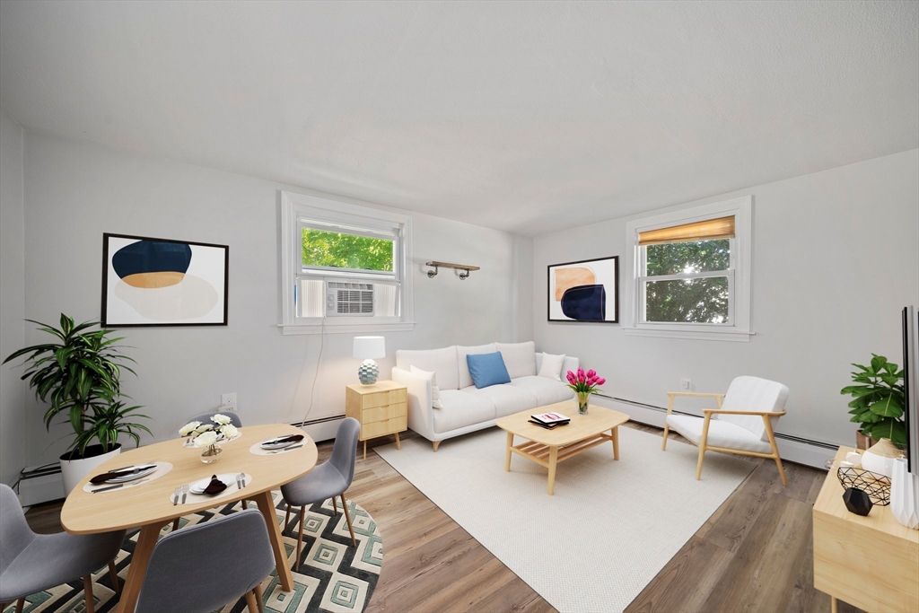 86 High Street Randolph, MA 02368 - Photo 17 of 28 a living room with furniture and a potted plant