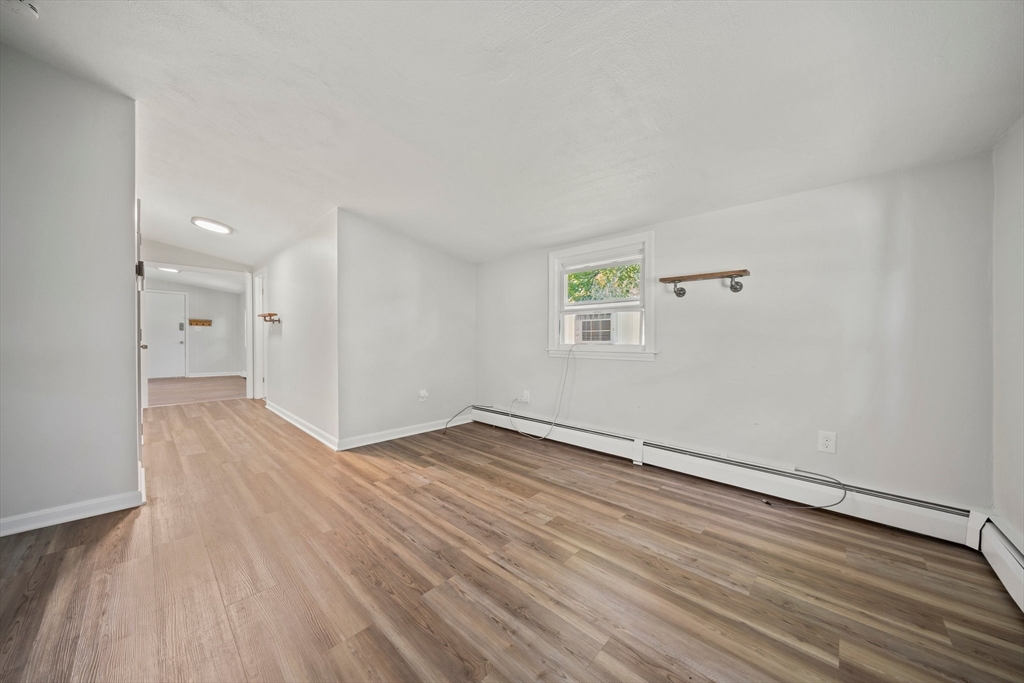 86 High Street Randolph, MA 02368 - Photo 19 of 28 an empty room with wooden floor and windows