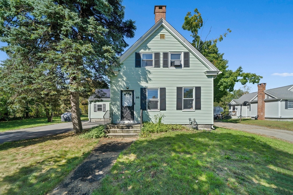 86 High Street Randolph, MA 02368 - Photo 2 of 28 a front view of a house with a yard