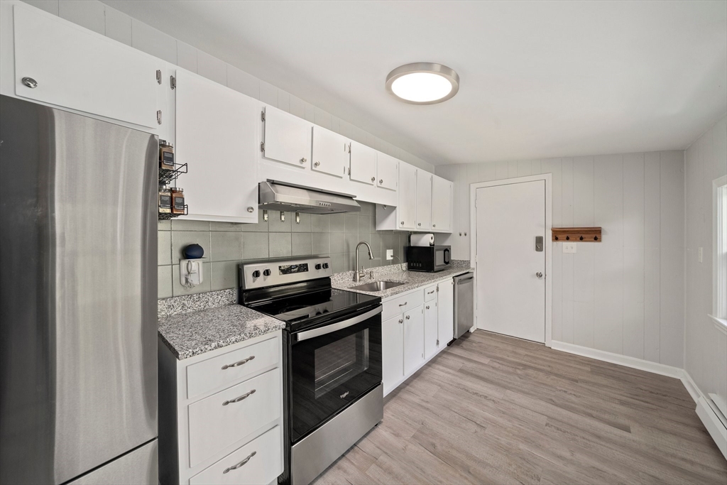 86 High Street Randolph, MA 02368 - Photo 21 of 28 a kitchen with granite countertop a refrigerator stove top oven and sink