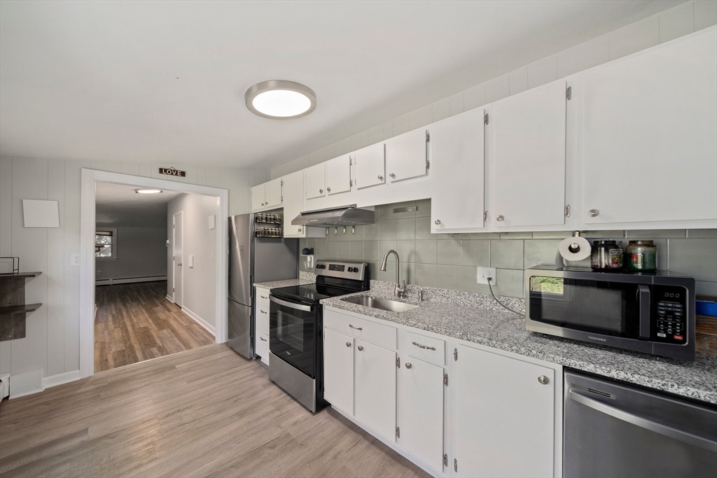 86 High Street Randolph, MA 02368 - Photo 22 of 28 a kitchen with granite countertop a sink stainless steel appliances and cabinets