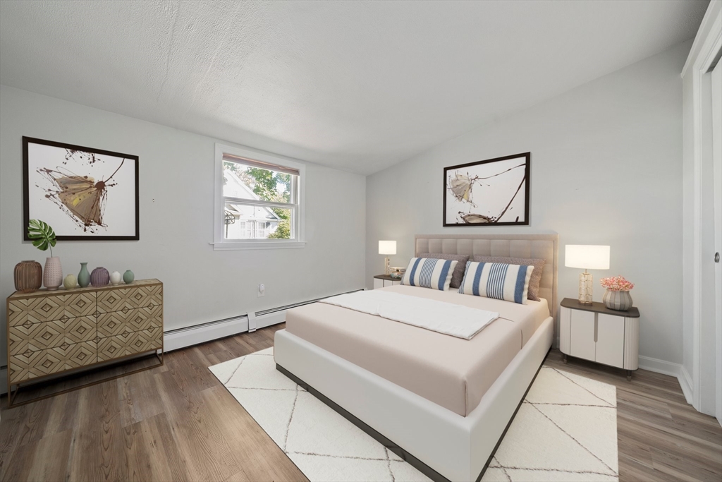 86 High Street Randolph, MA 02368 - Photo 23 of 28 a bedroom with a bed and a couch