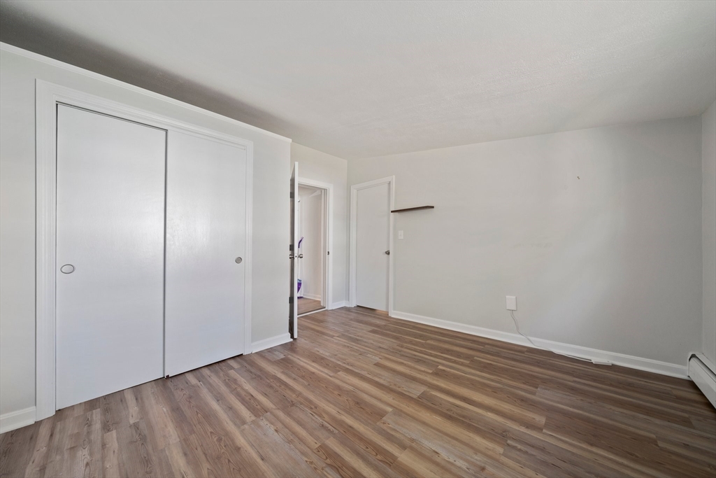 86 High Street Randolph, MA 02368 - Photo 25 of 28 a view of an empty room with wooden floor