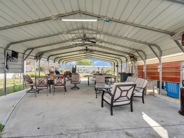 a view of a kitchen with a sink a refrigerator and wooden floor