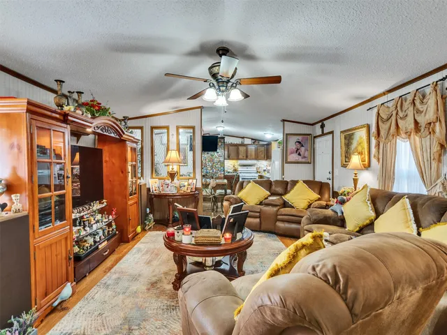 a kitchen with stainless steel appliances kitchen island granite countertop a refrigerator and a stove top oven