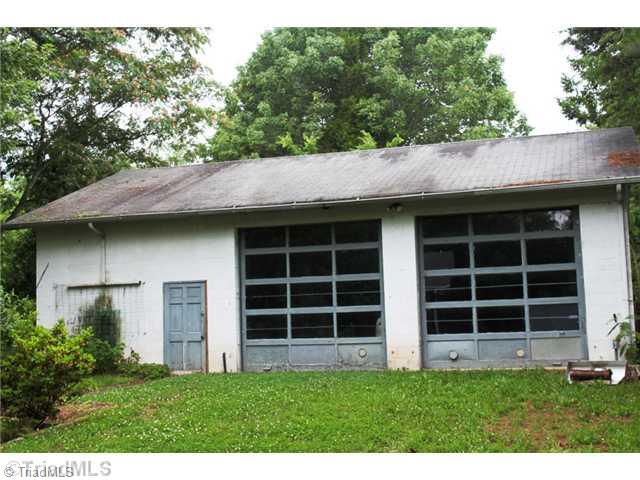 343 Beauchamp Road Advance, NC 27006 - Photo 4 of 5 Outbuilding. Detached two bay garage. Bay on right has full pit for working under vehicles. Garage includes storage and work benches.
