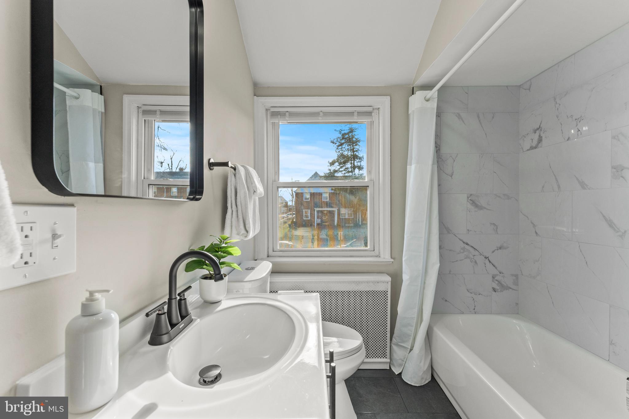 1324 Crofton Road Baltimore, MD 21239 - Photo 16 of 24 a bathroom with a tub sink and mirror