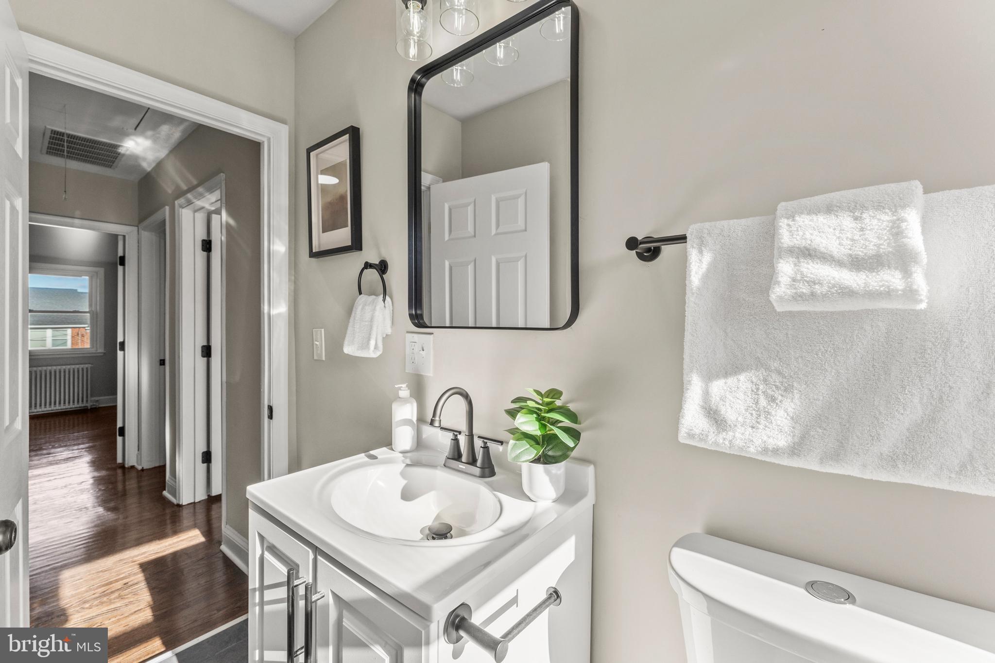 1324 Crofton Road Baltimore, MD 21239 - Photo 17 of 24 a bathroom with a sink and a mirror