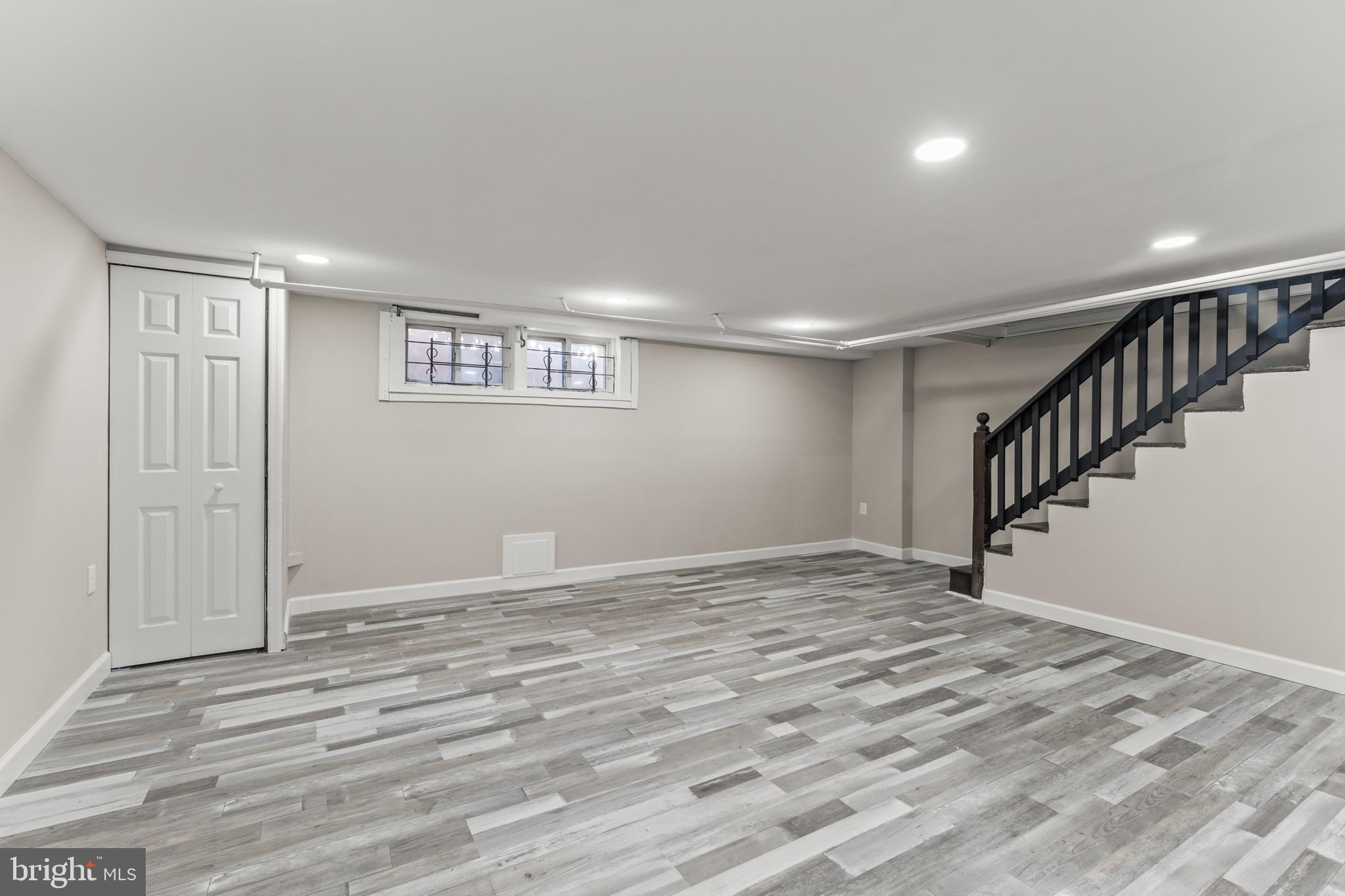 1324 Crofton Road Baltimore, MD 21239 - Photo 20 of 24 a view of an empty room with stairs and a window