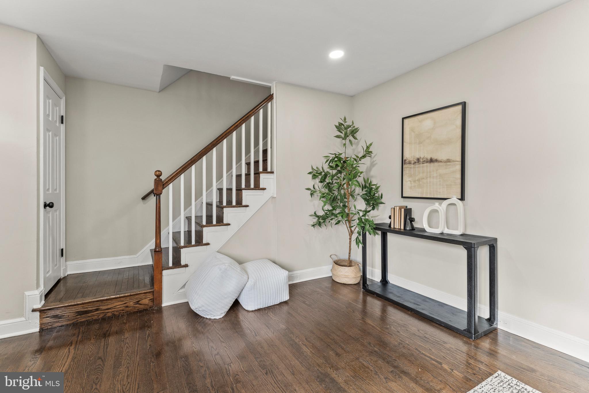 1324 Crofton Road Baltimore, MD 21239 - Photo 5 of 24 a living room with wooden floor and a potted plant