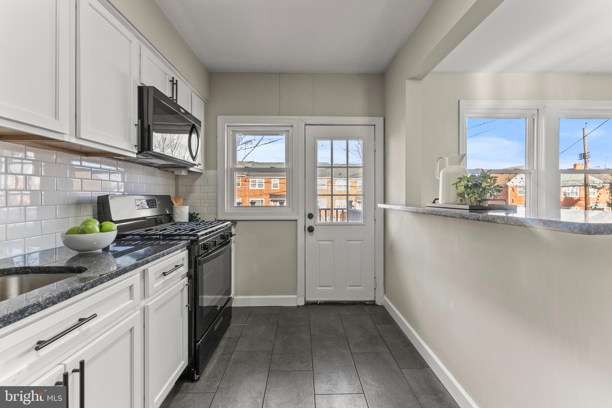 1324 Crofton Road Baltimore, MD 21239 - Photo 8 of 24 a kitchen with stainless steel appliances a sink stove and cabinets