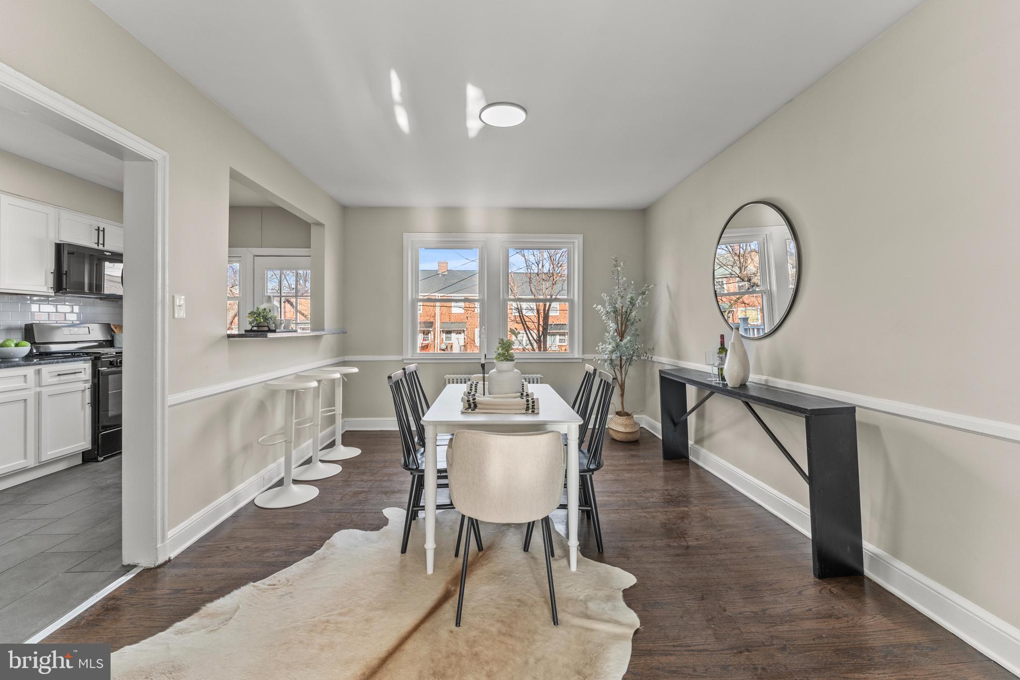 1324 Crofton Road Baltimore, MD 21239 - Photo 10 of 24 a dining room with furniture a chandelier and wooden floor