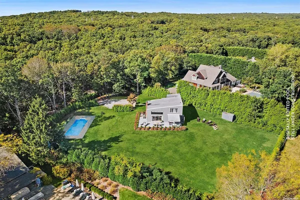 an aerial view of a house with a yard