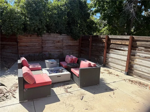 a backyard of a house with table and chairs