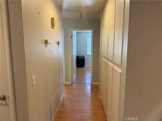 a kitchen with refrigerator and cabinets