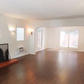 a view of a livingroom with wooden floor and a window