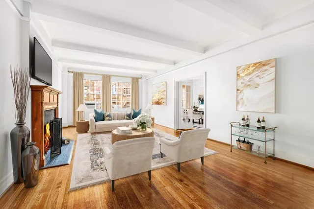 a living room with furniture wooden floor and a flat screen tv