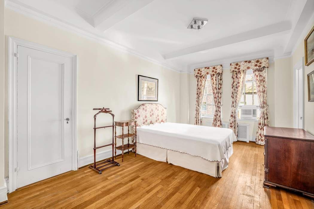 130 East 75th Street, Unit 3B Manhattan, NY 10021 - Photo 12 of 15 a spacious bedroom with a bed and a window