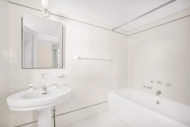 a spacious bedroom with a bed and a window