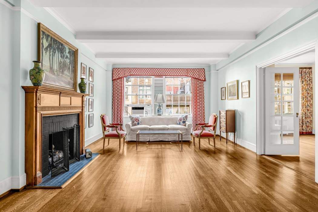 130 East 75th Street, Unit 3B Manhattan, NY 10021 - Photo 2 of 15 a living room with furniture and a fireplace