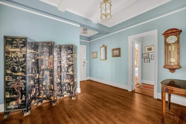 a kitchen with granite countertop a refrigerator stove and white cabinets