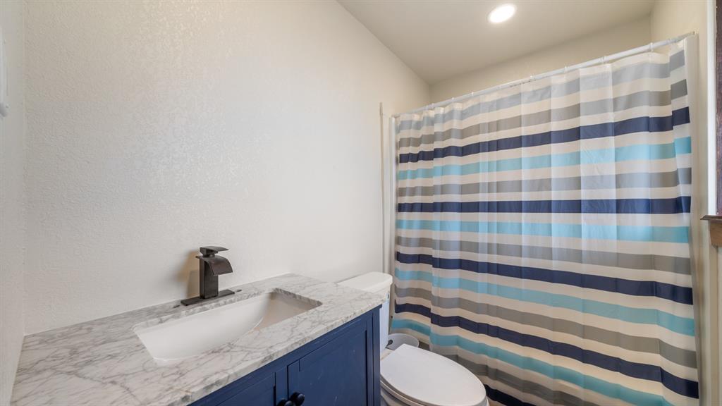 1123 Tbd County Road Fruitvale, TX 75127 - Photo 17 of 31 a bathroom with a granite countertop sink a toilet and a mirror
