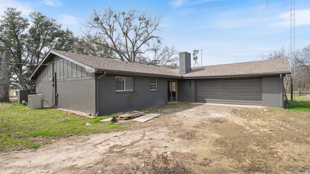 1123 Tbd County Road Fruitvale, TX 75127 - Photo 22 of 31 a front view of a house with a yard and garage