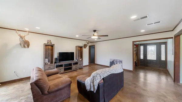 a living room with furniture and a large window