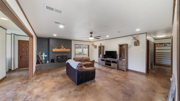 a bathroom with a granite countertop sink a toilet and a mirror