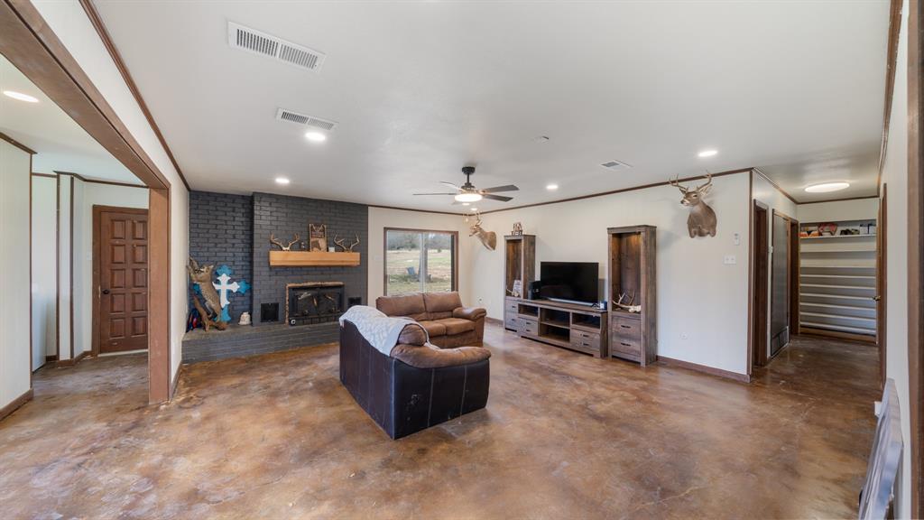 1123 Tbd County Road Fruitvale, TX 75127 - Photo 9 of 31 a living room with furniture a flat screen tv and fireplace