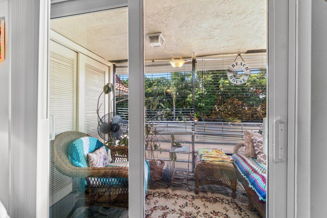 1124 Northwest 13th Street, Unit 204A Boca Raton, FL 33486 - Photo 22 of 30 a balcony with table and chairs