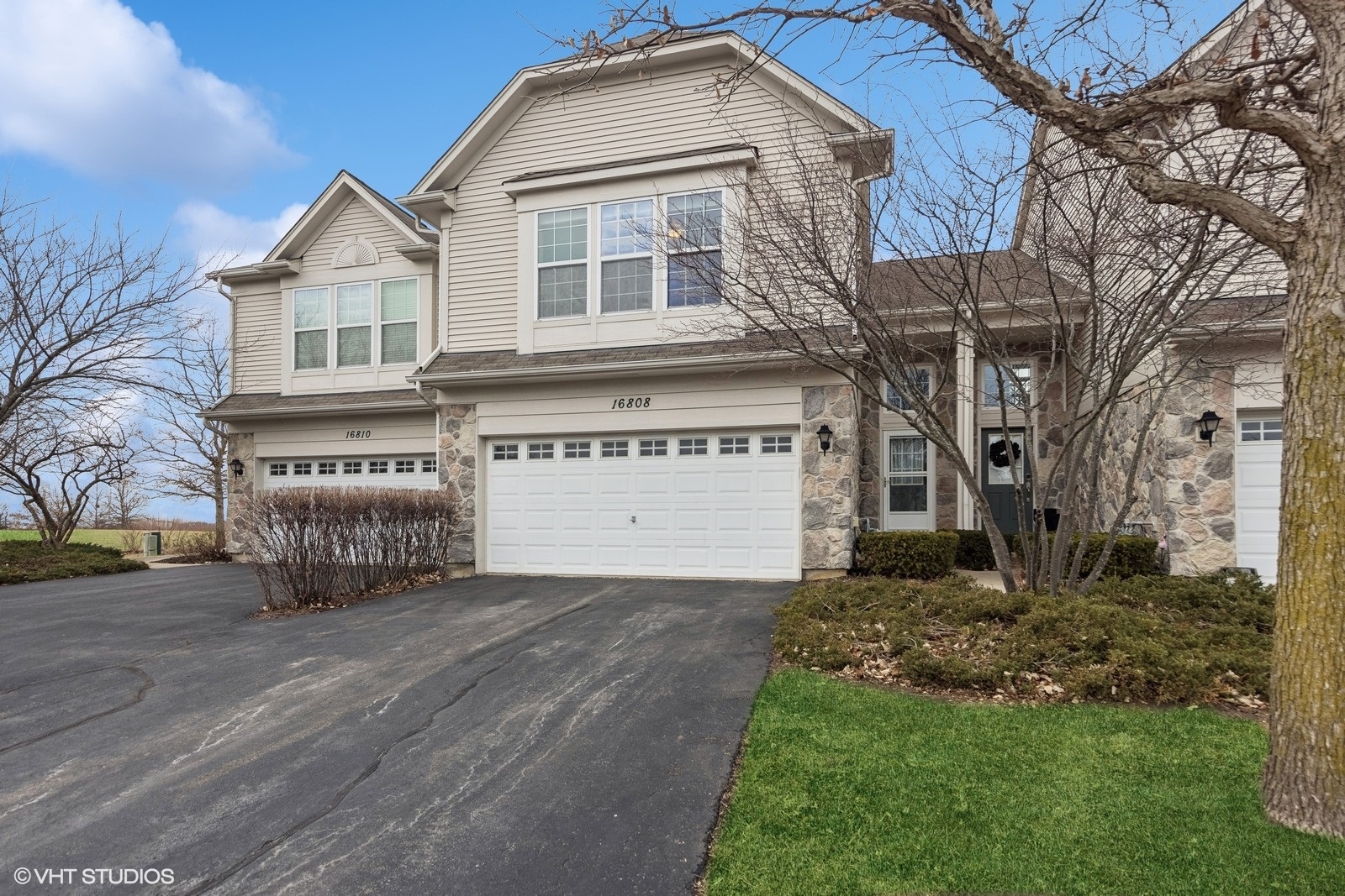 16808 Locust Lane Lockport, IL 60441 - Photo 1 of 20 a front view of a house with a garden and trees