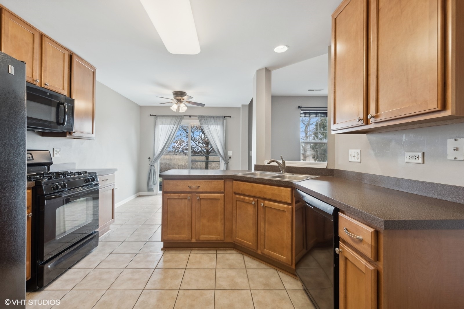 16808 Locust Lane Lockport, IL 60441 - Photo 6 of 20 a kitchen with stainless steel appliances granite countertop a sink and stove top oven