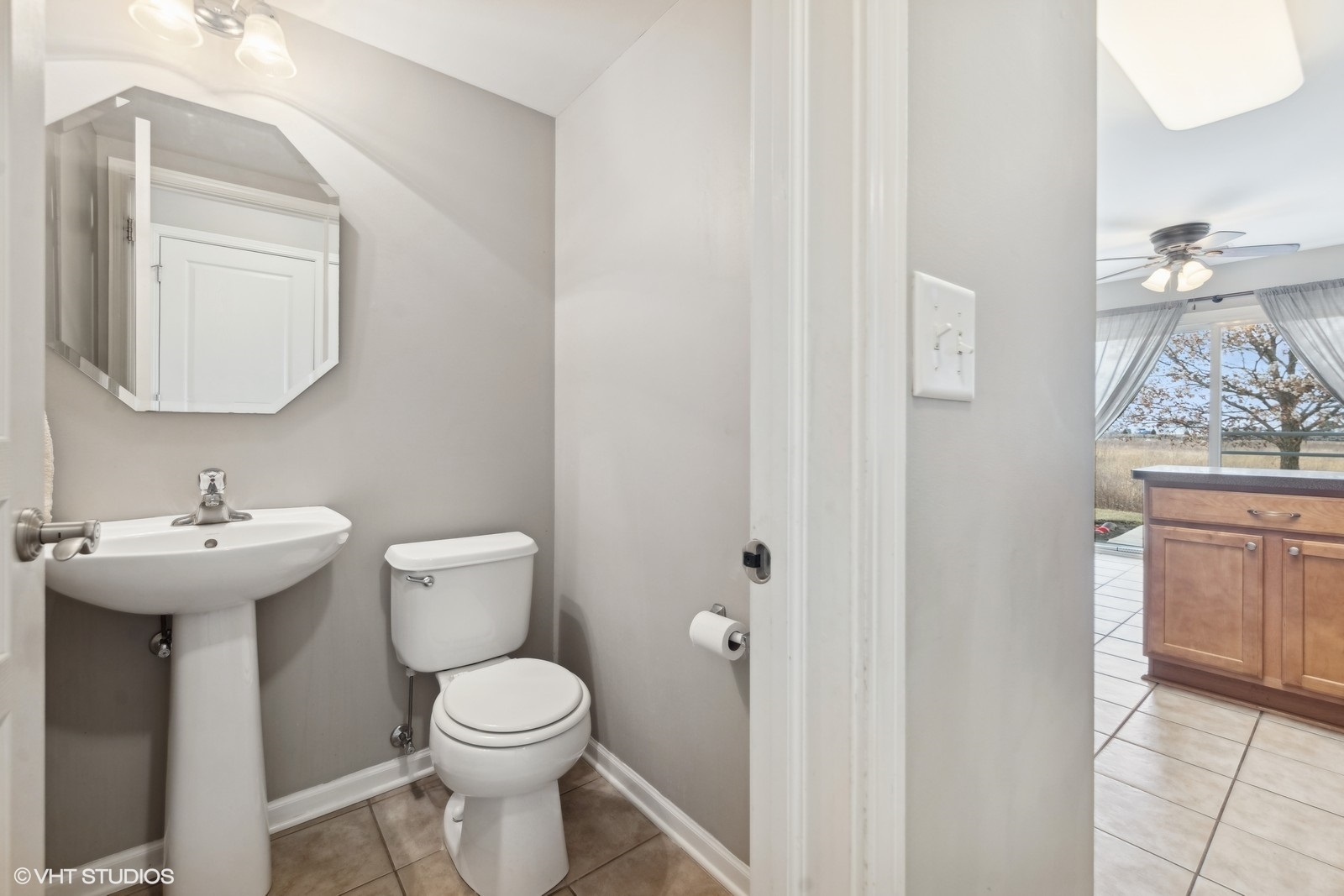 16808 Locust Lane Lockport, IL 60441 - Photo 9 of 20 a bathroom with a toilet a sink and mirror