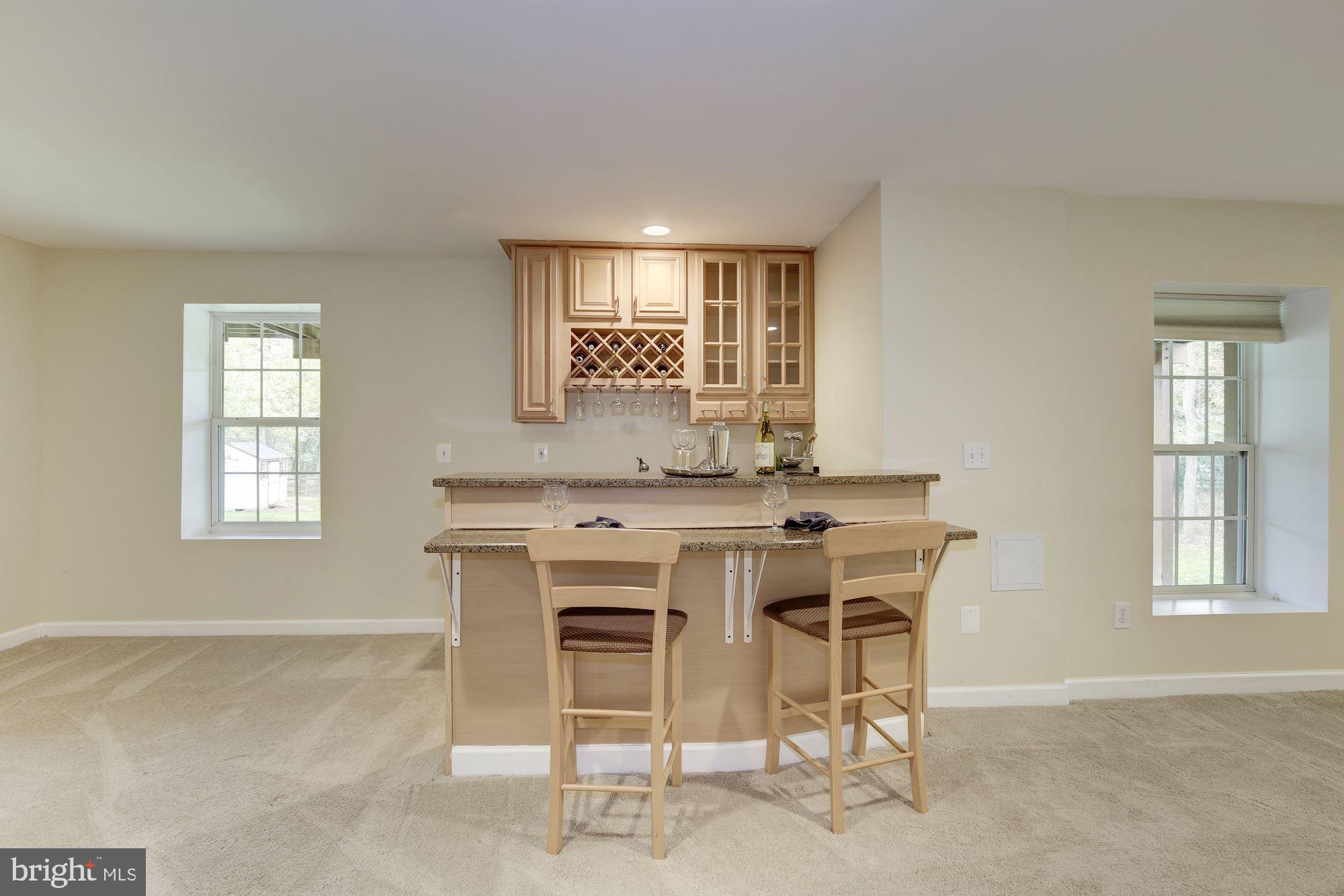 18815 Severn Road Gaithersburg, MD 20879 - Photo 29 of 38 Wet bar conveys a mini refrigerator & seating area