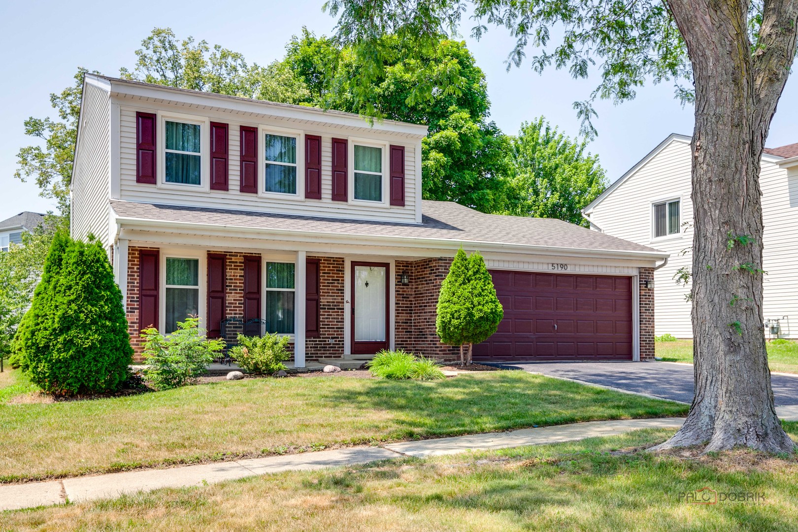 5190 Chambers Drive Hoffman Estates, IL 60010 - Photo 1 of 23 a front view of a house with garden