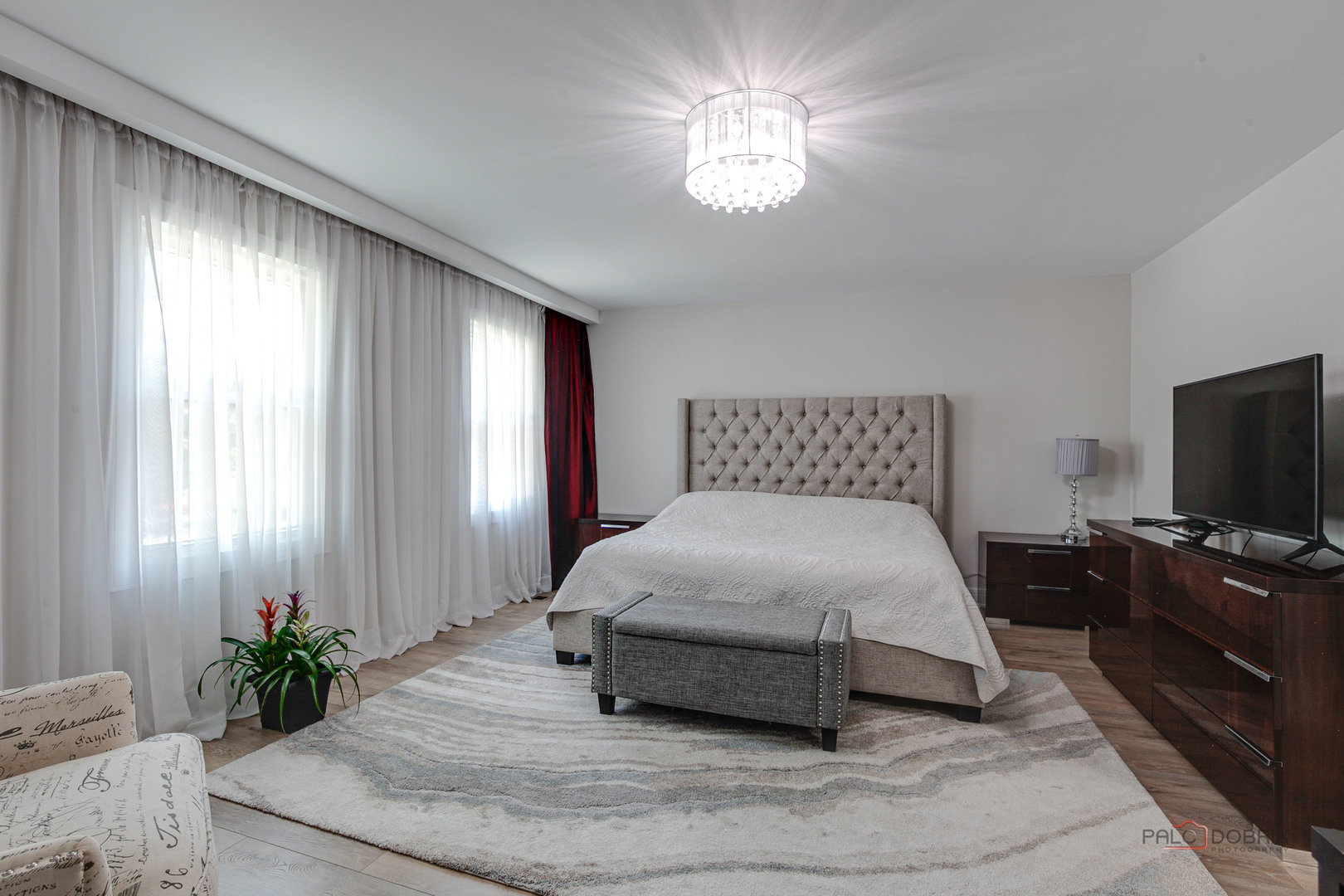 5190 Chambers Drive Hoffman Estates, IL 60010 - Photo 16 of 23 a bedroom with a large bed and a flat tv screen on a dresser