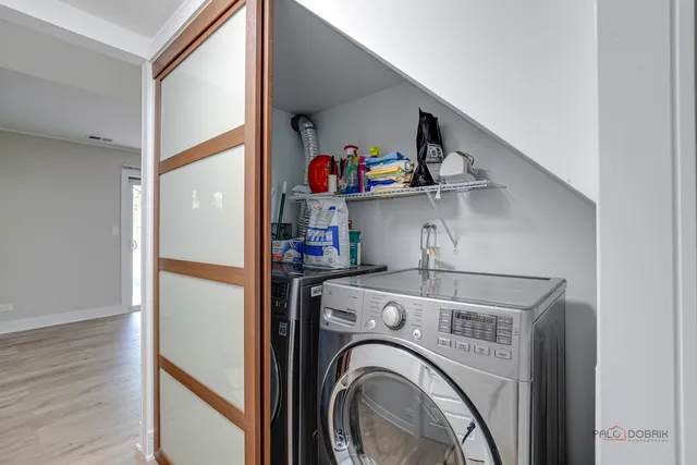 a view of storage and utility room with washer and dryer