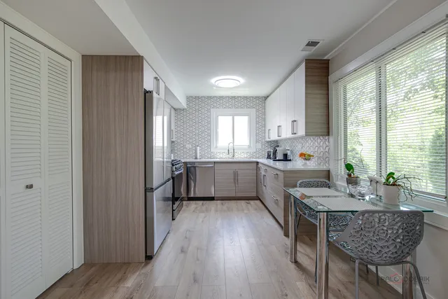 a kitchen with granite countertop lots of counter top space and wooden floor