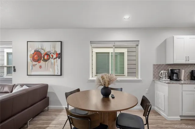 a dining room with furniture and wooden floor